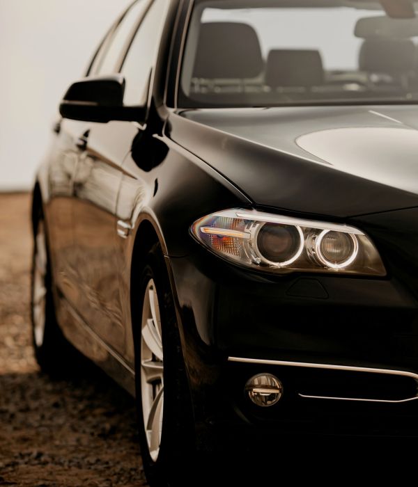 Headlight of modern prestigious black car close up.